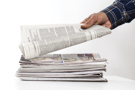 Man hand holding newspaper on tableの写真素材