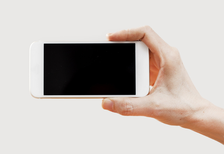 Hand holding mobile phoneの写真素材