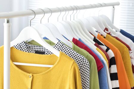 Collection of clothes hanging on rack