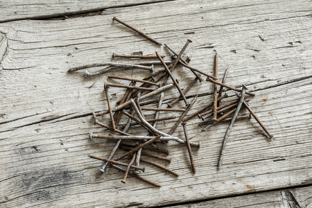 Rusty nails on wooden backgroundの写真素材