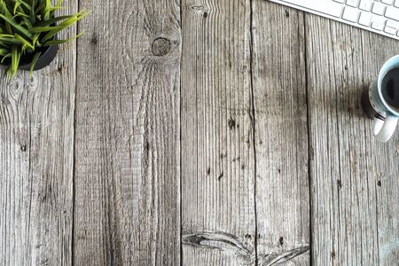 Wooden table with keyboardの写真素材