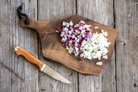 Chopped onions on chopping board