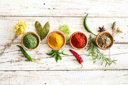 Spices and herbs on wooden background