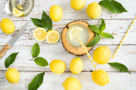 Lemon with lemonade on wooden backgroundの写真素材