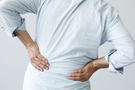 Old man with back painの写真素材