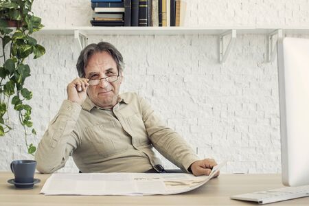 Senior man reading newspaperの写真素材