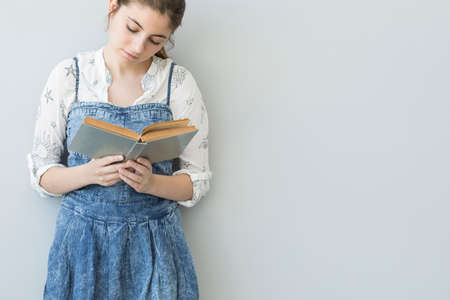 Young girl is reading bookの写真素材
