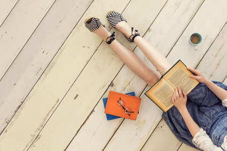 Reading book while sitting on floorの写真素材