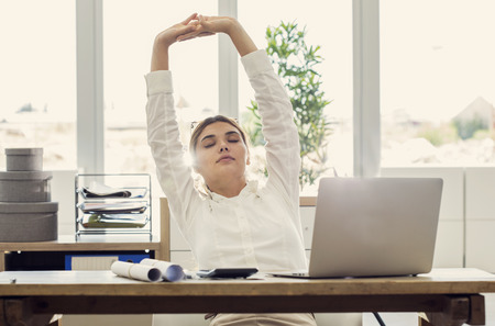 Businesswoman stretching her bodyの写真素材