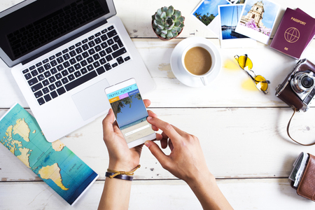 Travel booking website in mobile phone screenの写真素材