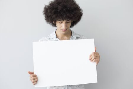 Young man holding a bannerの写真素材