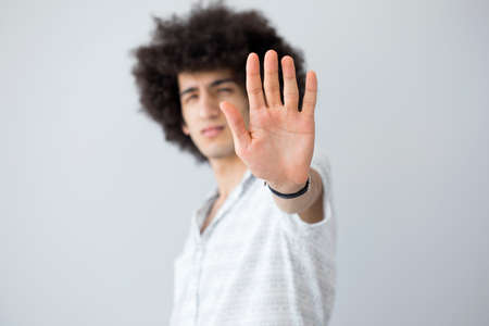 Young man showing stop gestureの写真素材