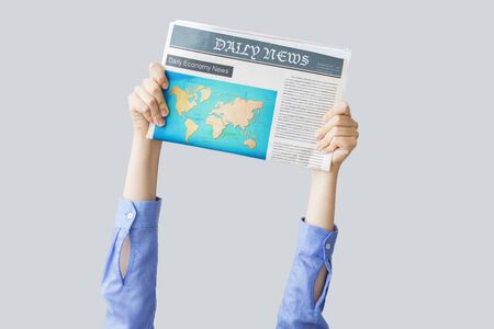 Woman hands holding newspaperの写真素材
