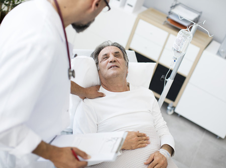 Doctor talking to patient in hospital bed