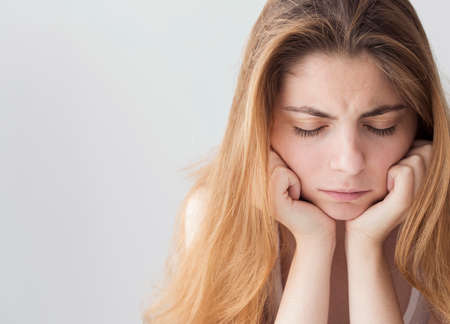 Portrait of sad depressed young womanの写真素材