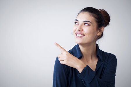 Portrait of cheerful young woman showing copyspace