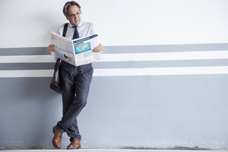 Man reading newspaper at outdoor