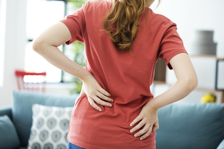 Young woman with back painの写真素材