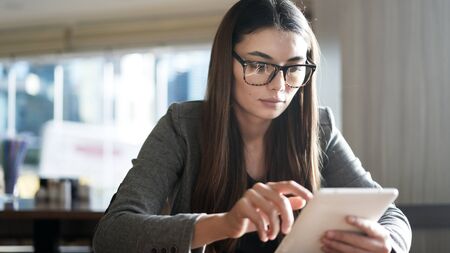 Businesswoman using digital tablet in officeの写真素材