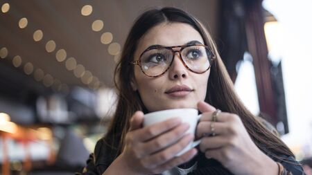 Young woman drinking coffeeの写真素材