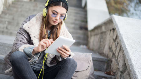 Young woman using digital tablet in outdoors