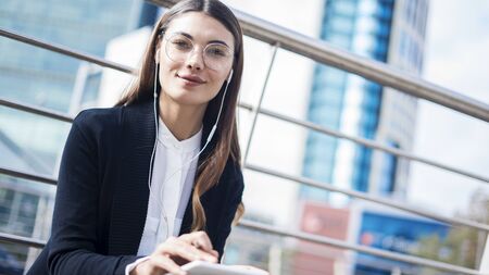 Woman using mobile phone in outdoorsの写真素材