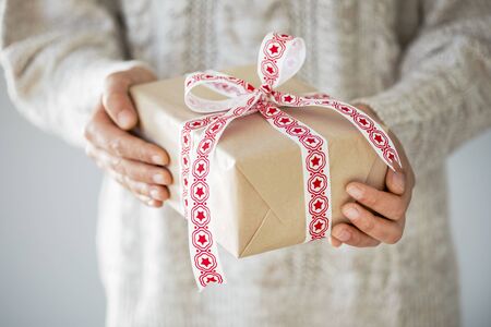 Woman holding gift box close up view