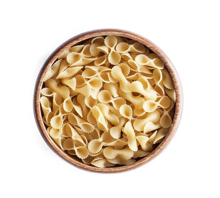 Pasta in wooden bowl on isolated white backgroundの写真素材