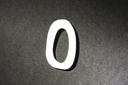 Number zero on grey backgroundの写真素材
