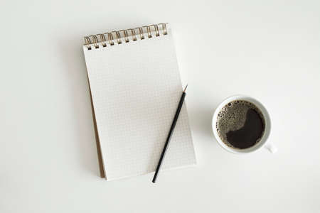 Spiral square Notebook, pencil and coffee on white backgroundの写真素材