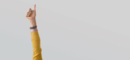 Woman hand with thumb up