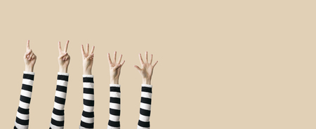 Raised up hands and fingers showing numericalの写真素材