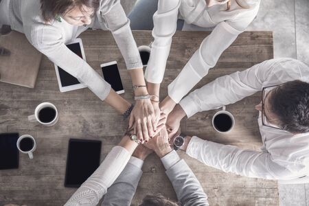 Group of people hands up together