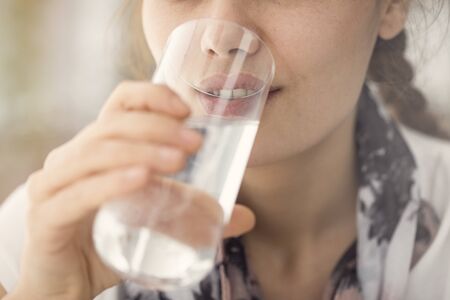 Young woman having glass of water