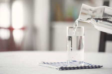Pouring water to  glass, kitchen, home