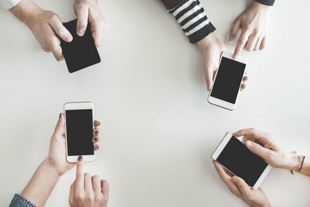 Different people using their mobile phonesの写真素材