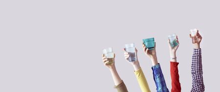 Different people holding water glassの写真素材