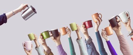 Many different arms raised up holding coffee cupの写真素材