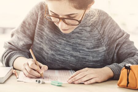 Young female student in examinationの写真素材