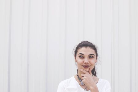 Young woman looking tricky upwardsの写真素材