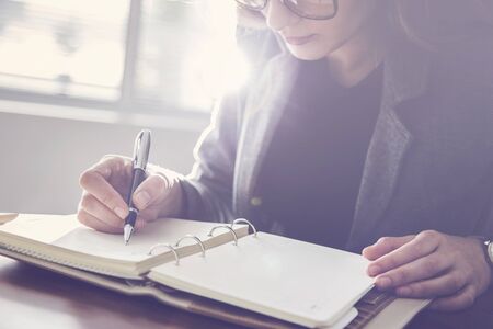 Woman writing on notebook close up viewの写真素材