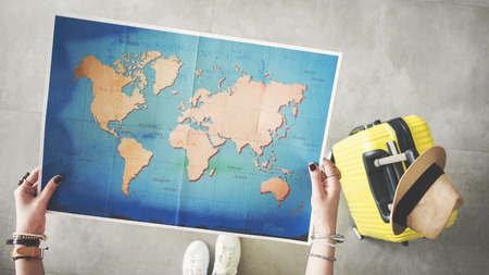 Woman holding world map travel conceptの写真素材