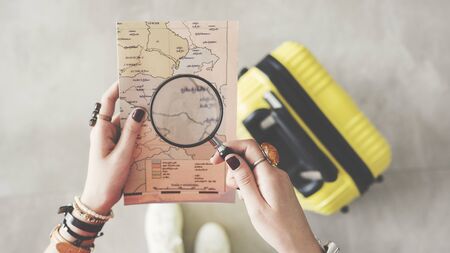 Woman holding world map travel conceptの写真素材