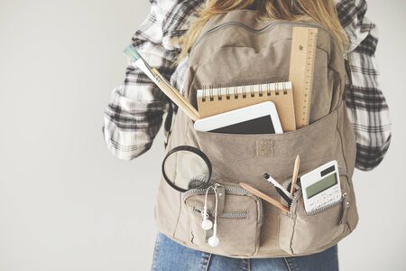 Student carrying backpack with stationery equipmentsの写真素材