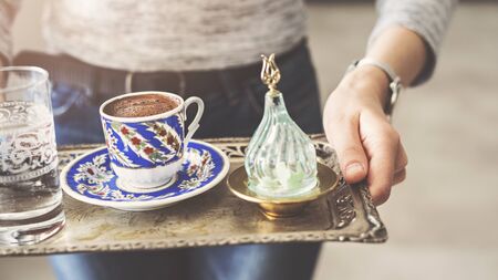 Woman serving a cup of Turkish coffeeの写真素材