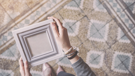 Young woman holding frame