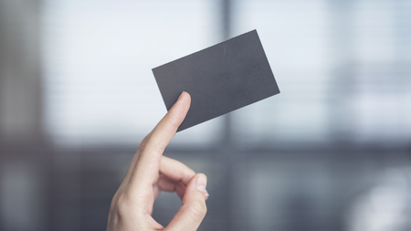 Woman holding the business cardの写真素材