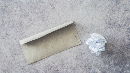 Crumpled paper ball and envelopeの写真素材