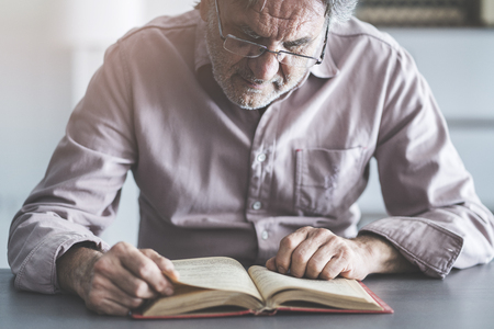 Man reading book on the tableの写真素材
