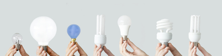 Hands holding the light bulbsの写真素材